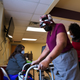 A woman approaches her seat while a medical technician waits to administer her COVID-19 vaccine on February 12, 2021 in Louisville, Kentucky, the first day that Norton Healthcare offered the vaccination in predominantly black areas of the city.